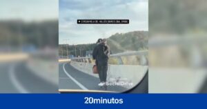 Dos personas circulan montadas en el mismo patinete por una autopista de Barcelona