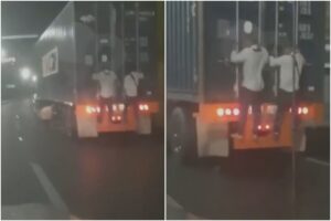 Grabaron a dos hombres que viajaban guindados en la parte trasera de una gandola por la autopista Caracas-La Guaira (+Video)