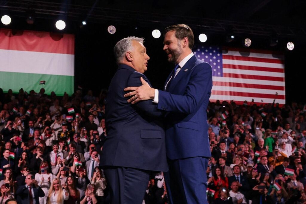 TOPSHOT - US Vice President JD Vance (R) and Hungarian Prime Minister Viktor Orban shake hands on stage during a "Day of Friendship" event at MTK Sportpark in Budapest, Hungary on April 7, 2026. US Vice President JD Vance is in Hungary to deliver the US President's support to his ally, nationalist Prime Minister Viktor Orban, ahead of tightly contested parliamentary elections scheduled for April 12, 2026. (Photo by Jonathan Ernst / POOL / AFP)