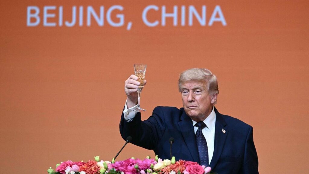 TOPSHOT - US President Donald Trump makes a toast as he attends a state banquet with China's President Xi Jinping at the Great Hall of the People in Beijing on May 14, 2026. (Photo by Brendan SMIALOWSKI / AFP)