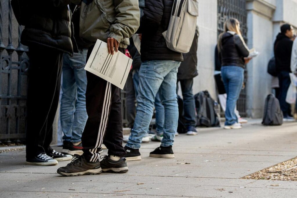 Archivo - Varias personas hacen cola para conseguir documentación de la regularización en una Oficina de Asistencia en Materia de Registro, a 22 de abril de 2026, en Madrid (España).